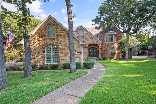 view of front of home with french doors and a front yard