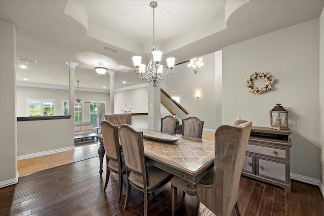 dining area with a tray ceiling, ornamental molding, ornate columns, and dark hardwood / wood-style floors