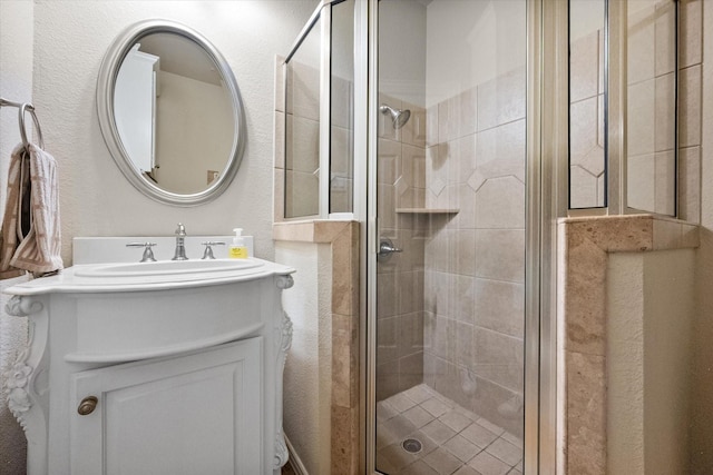 bathroom featuring vanity and a shower with shower door