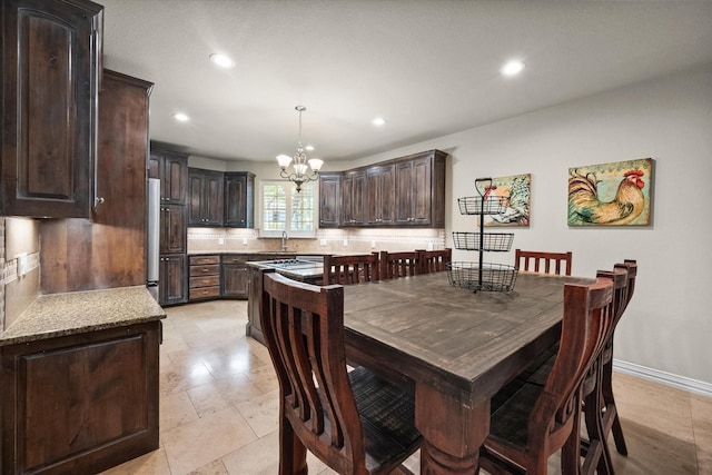 dining area featuring a notable chandelier and sink