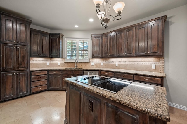 kitchen featuring sink, pendant lighting, a kitchen island, black electric stovetop, and dark brown cabinetry