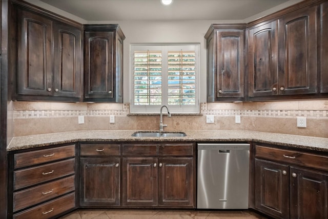 kitchen featuring dishwasher, dark brown cabinetry, light stone countertops, backsplash, and sink