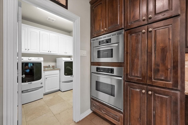 kitchen featuring white cabinetry, sink, double oven, and light tile patterned floors