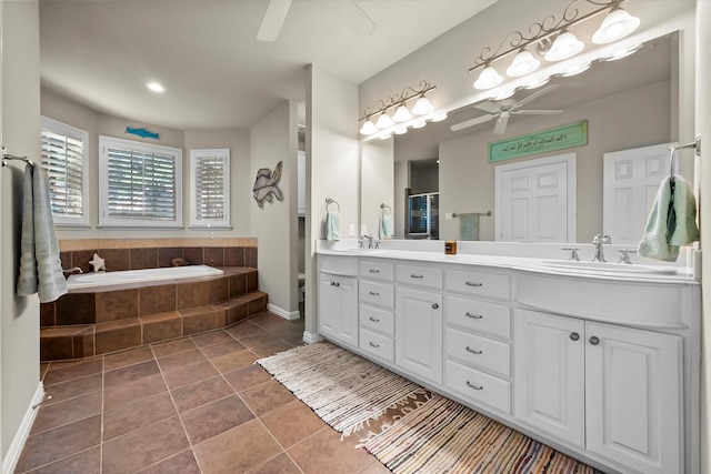 bathroom with a relaxing tiled tub, vanity, tile patterned flooring, and ceiling fan