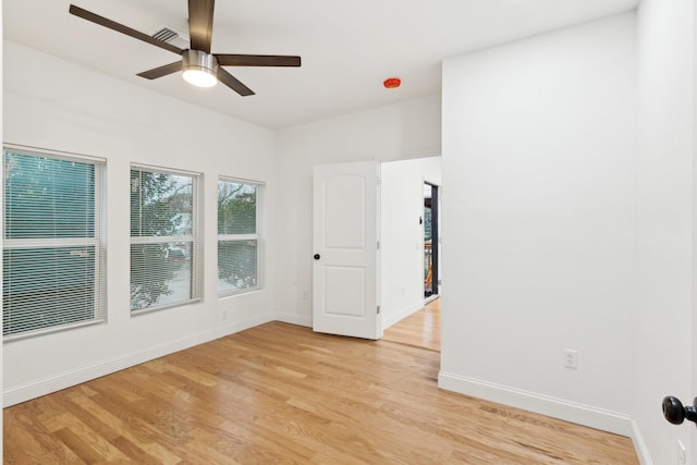 empty room featuring ceiling fan and light hardwood / wood-style flooring