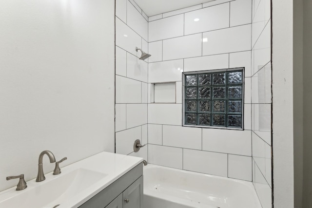 bathroom with vanity and tiled shower / bath