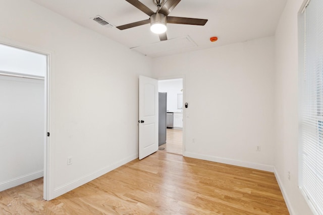 unfurnished bedroom featuring a closet, light hardwood / wood-style flooring, and ceiling fan