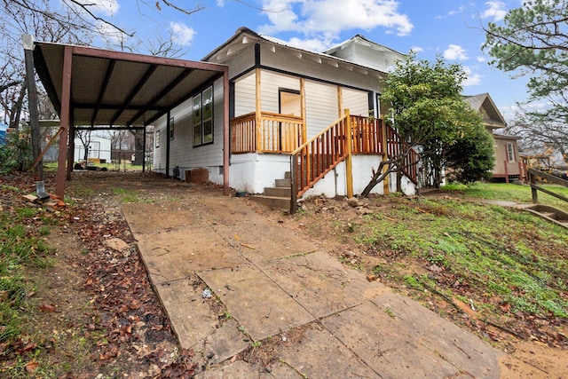 view of side of property with a carport