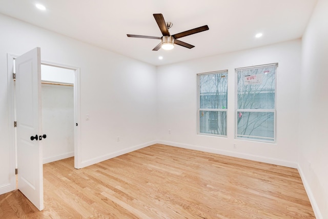 spare room with light hardwood / wood-style flooring and ceiling fan