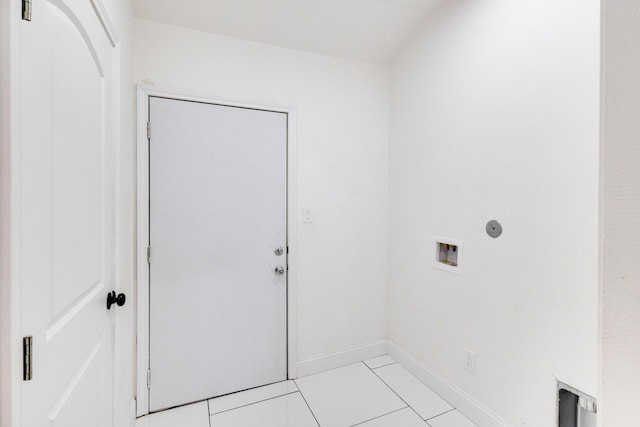 washroom with light tile patterned floors and hookup for a washing machine