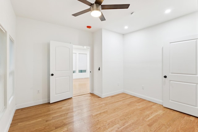 unfurnished bedroom with ceiling fan and light hardwood / wood-style floors