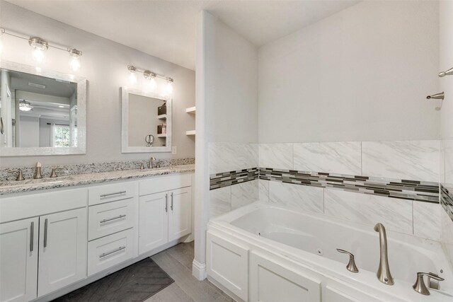 bathroom featuring vanity and a bath