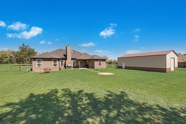 rear view of property with a yard