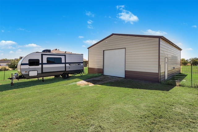 view of outbuilding featuring a yard and a garage