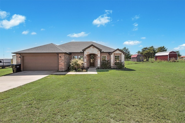 french country style house with a front lawn and a garage