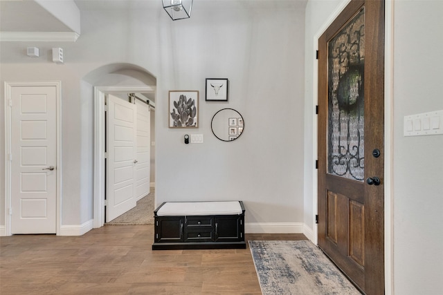 entrance foyer featuring ornamental molding and light wood-type flooring