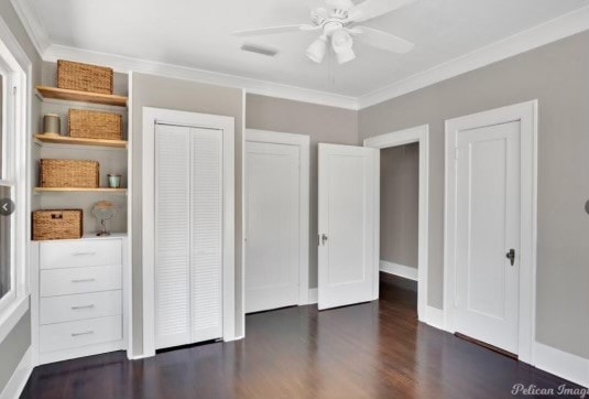 unfurnished bedroom featuring dark hardwood / wood-style floors, ceiling fan, and ornamental molding