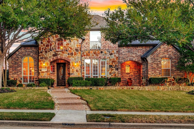 tudor-style house with a yard