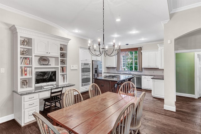 dining area featuring a notable chandelier, dark hardwood / wood-style flooring, ornamental molding, and sink