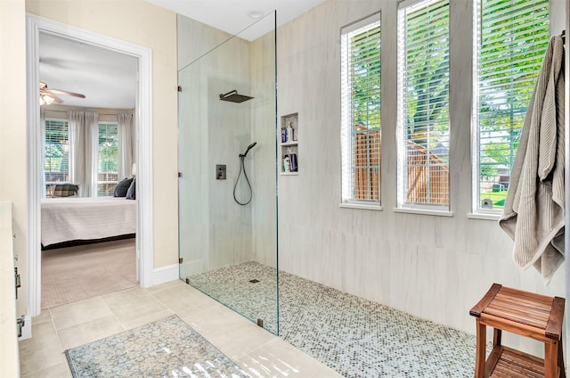 bathroom with a tile shower, tile patterned floors, and ceiling fan