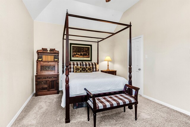 carpeted bedroom with lofted ceiling