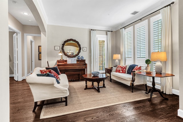 living room with a chandelier, dark hardwood / wood-style flooring, and ornamental molding