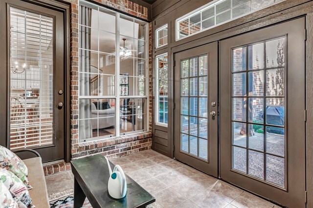 doorway with tile patterned flooring, french doors, and ceiling fan