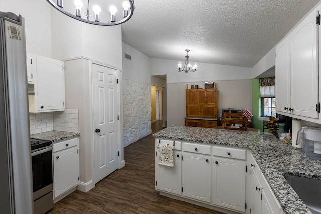 kitchen with white cabinetry, dark hardwood / wood-style flooring, an inviting chandelier, and appliances with stainless steel finishes