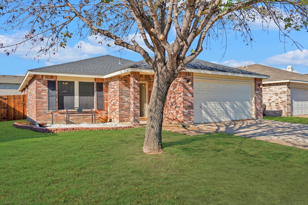 single story home featuring a front yard and a garage