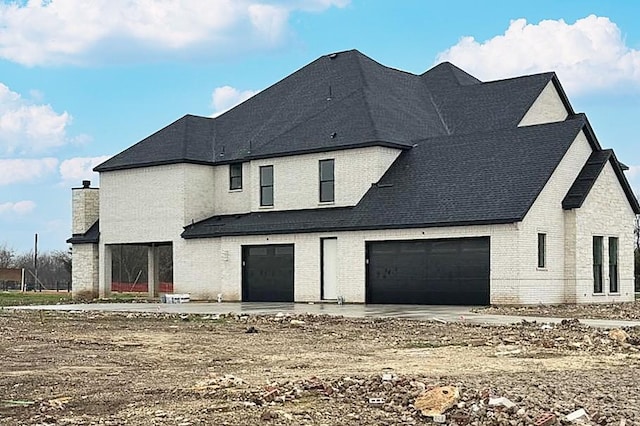 back of property featuring a garage