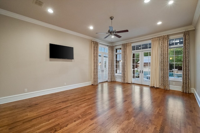 empty room featuring french doors, visible vents, crown molding, and wood finished floors