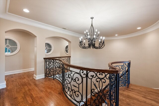 corridor featuring recessed lighting, visible vents, an upstairs landing, and wood finished floors