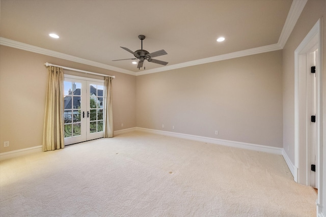 empty room featuring light carpet, baseboards, ornamental molding, and french doors