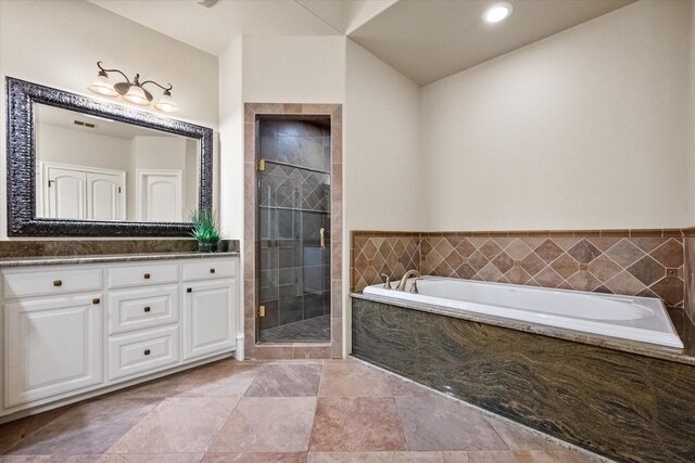 bathroom featuring a garden tub, a shower stall, and vanity