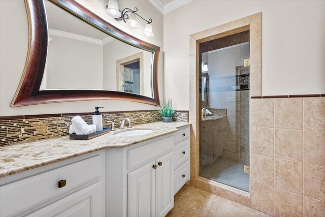 full bathroom featuring tile patterned flooring, a shower stall, crown molding, and vanity