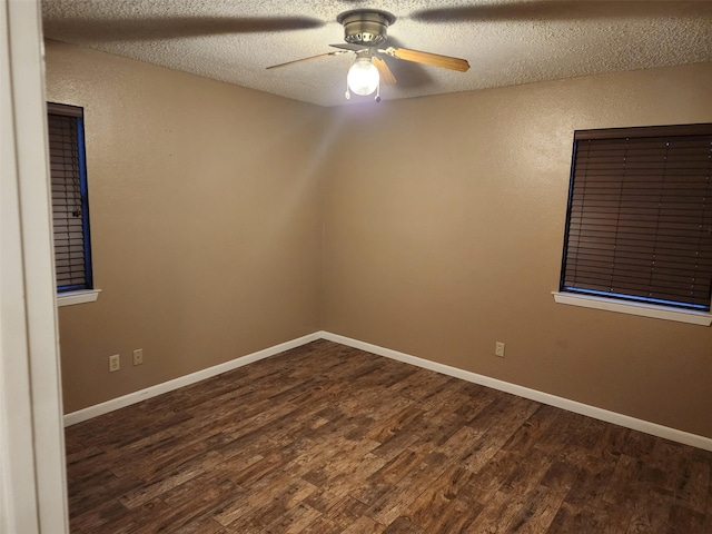 unfurnished room featuring ceiling fan, dark hardwood / wood-style floors, and a textured ceiling