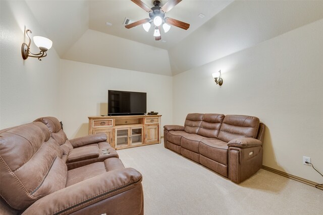 living room featuring vaulted ceiling, ceiling fan, carpet flooring, and a tray ceiling