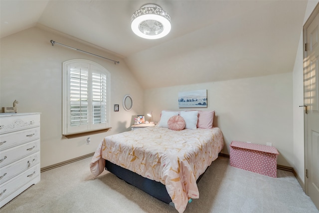 bedroom with lofted ceiling and light colored carpet