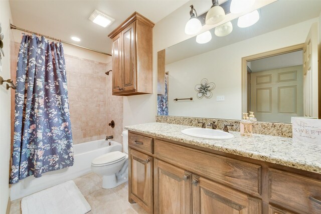 full bathroom with tile patterned floors, toilet, vanity, and shower / bath combo