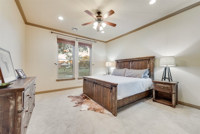 carpeted bedroom featuring ceiling fan and crown molding