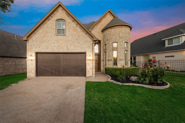 french provincial home featuring a yard and a garage