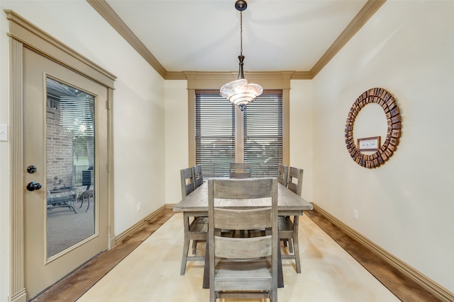 dining area with plenty of natural light and crown molding