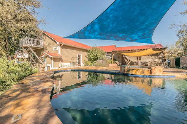 view of pool with an in ground hot tub