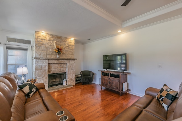 living room with a fireplace, hardwood / wood-style flooring, and crown molding