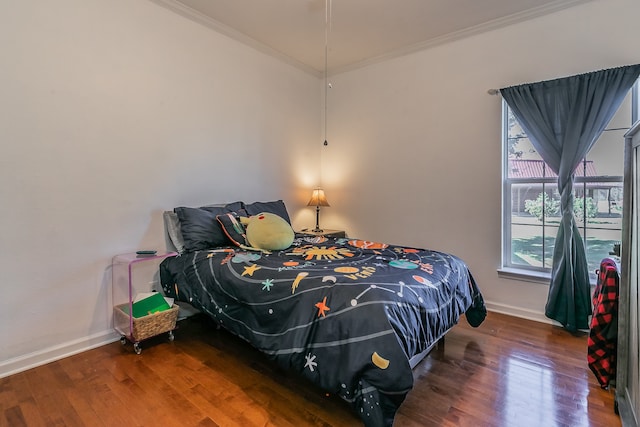 bedroom with hardwood / wood-style flooring and crown molding