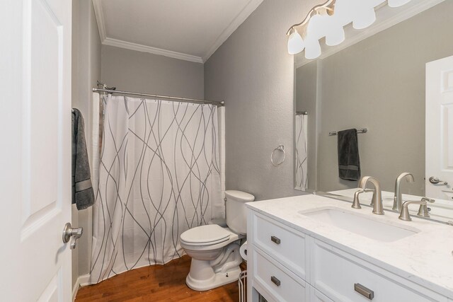 bathroom featuring crown molding, toilet, vanity, and hardwood / wood-style flooring