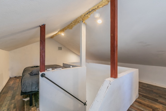 bonus room with dark hardwood / wood-style floors and lofted ceiling