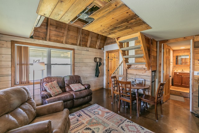 living room with wooden walls and lofted ceiling