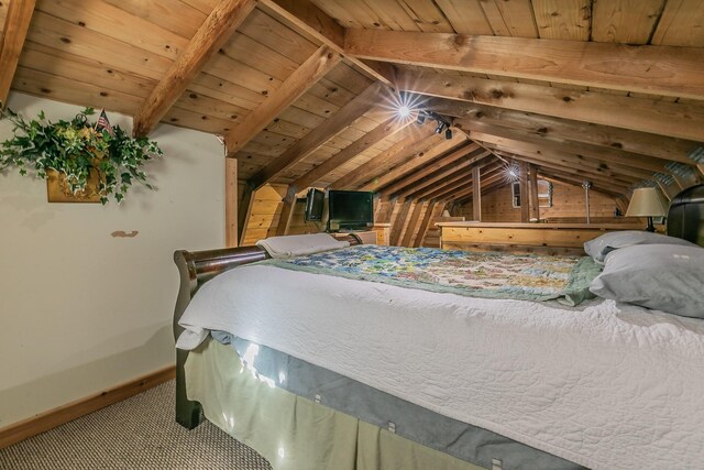 bedroom with vaulted ceiling with beams and wooden ceiling