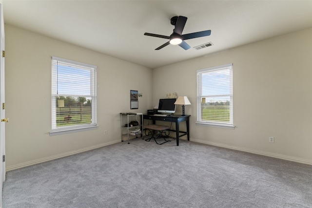 carpeted office space with ceiling fan